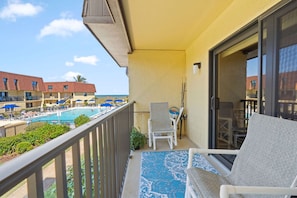 Private balcony with outdoor seating and pool views
