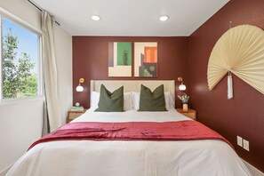 The bedroom offers a luxurious retreat, with a bed that promises restful nights and a room that feels like a private oasis.