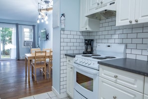 Fully equipped kitchen for easy meal prep. Dining table for four.
