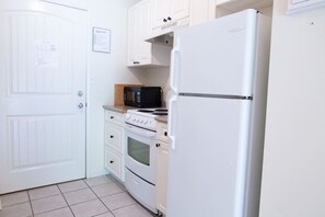 Fully equipped kitchen for easy meal prep. Dining table for three.