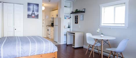 Fully equipped kitchen leads into the main area.