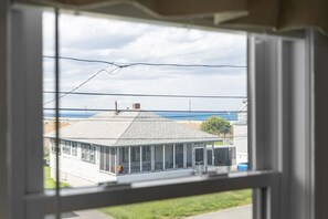 Unwind in comfort upstairs, with a full bed and a subtle glimpse of the ocean’s beauty!