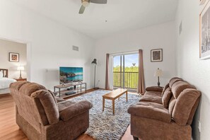 Living area with high ceilings, ample seating, and Smart TV