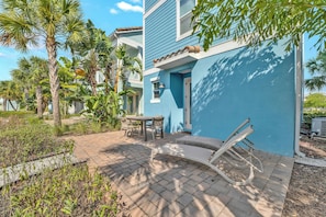 Soak up the sun on the private patio, surrounded by lush tropical landscaping