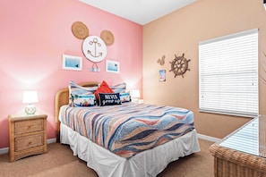 Bedroom retreat showcases a chic queen bed & smart TV