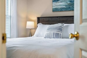 This 2nd floor queen bedroom includes a TV & ceiling fan