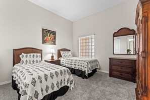 This bedroom retreat features two cozy twin beds