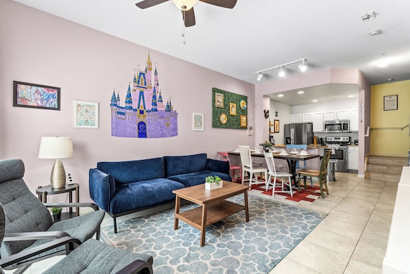 Cozy and spacious living area with, ceiling fan & smart TV
