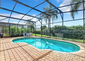 Private fenced in pool with outdoor seating