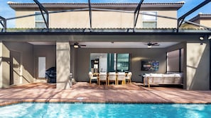 Outdoor dining by the pool with ample seating