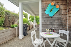 Enjoy the front covered patio with outdoor seating and a BBQ.