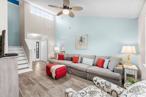 Open-concept living area with warm coastal decor—perfect for making vacation memories.