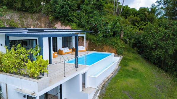 Panoramic jungle and ocean views from the outdoor lounge.