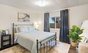 Queen room with full length mirror and smart tv