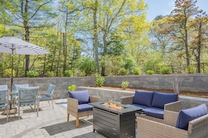 Outdoor patio with fire pit and bar area