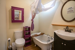 Whimsical bathroom with clawfoot tub.