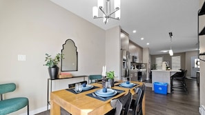 Dinner with flair! Enjoy meals at this stylish table, surrounded by comfortable chairs, a decorative mirror, and tasteful décor. Ready for a feast?