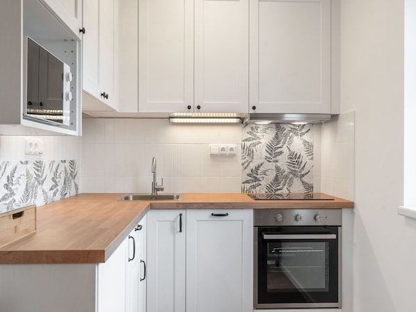 Kitchen, Countertop, Kitchen Appliance, Cabinetry, Flooring, Major Appliance, Interior Design, Wood, Sink, Plumbing Fixture