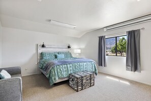Wake up to mountain views in this serene bedroom featuring a king bed and cozy, rustic touches.