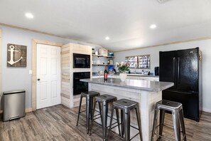 Rustic charm meets modern convenience in this inviting, open kitchen with island seating.