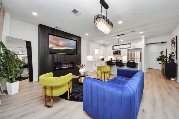 Step into a designer-curated living space where style meets serenity. Vibrant velvet seating, modern décor, and a sleek electric fireplace set the stage for memorable conversations, cozy nights, and photo-worthy moments.
