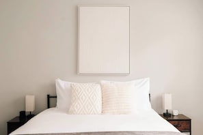The office has been converted to a sleeping area with a queen bed