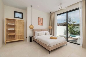 The master bedroom has a king-size bed, 2 large windows with sliding doors and black-out curtains. You have access to the pool and garden shared with Bedroom 2.