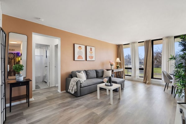 Bright and cozy living area with natural light and scenic greenery views—perfect for relaxing after a day of exploring