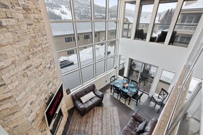 This is the view of the living room from the second floor, showcasing its cozy charm!  | Giant Steps Retreat, Brian Head, Utah | Voyax Luxury Vacation Rentals