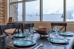 Gather around the dining table for meals and laughter! With seating for six and extra spots at the kitchen counter, plus a patio with a grill! | Giant Steps Retreat, Brian Head, Utah | Voyax Luxury Vacation Rentals
