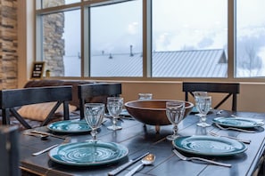 Gather around the dining table for meals and laughter! With seating for six and extra spots at the kitchen counter, plus a patio with a grill! | Giant Steps Retreat, Brian Head, Utah | Voyax Luxury Vacation Rentals