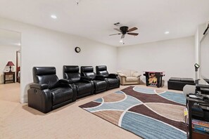 Relax in the theater room with cozy seating, a TV and DVD player. Perfect for movie nights! | Giant Steps Retreat, Brian Head, Utah | Voyax Luxury Vacation Rentals