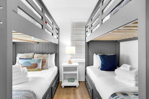 A fun bunk room with 2 full-size and 2 single bunk beds—perfect for kids or solo travelers looking for a comfy stay! | White Sands, Paradise Isles, Destina | Voyax Luxury Vacation Rentals