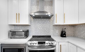 The kitchen has all the basic tools and utensils you need, conveniently located right next to the dining area for easy meals! | White Sands, Paradise Isles, Destin | Voyax Luxury Vacation Rentals