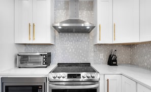The kitchen has all the basic tools and utensils you need, conveniently located right next to the dining area for easy meals! | White Sands, Paradise Isles, Destin | Voyax Luxury Vacation Rentals