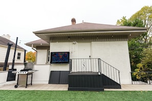 The rooftop patio complete with overhead lighting, a brand new grill, and patio tv!