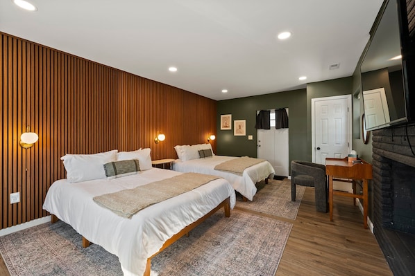 Our bedroom features two comfortable queen beds, perfect for a restful night’s sleep. Thoughtfully decorated, the space offers warm lighting and cozy linens to ensure you feel right at home.
