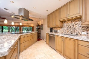 KGV-14P6 This gourmet kitchen features luxe countertops, custom cabinetry, and modern appliances?ready for any culinary adventure