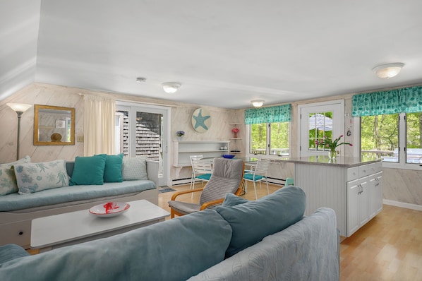 The cheerful open kitchen and living room as seen from the bedroom entry.