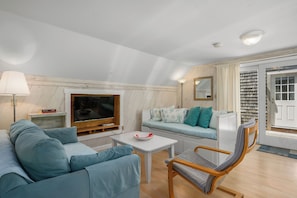 Smart TV viewing seating area with trundle and sofa bed shown
