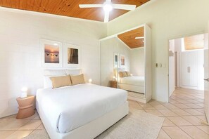 Unwind in the queen bedroom featuring a mirrored wardrobe for easy storage, gentle lighting, and cooling comfort from the ceiling fan and dedicated air conditioning.