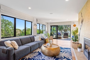 Spacious lounge with fireplace leading from the dining area