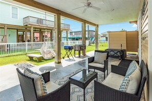 Comfortable seating on the outdoor patio with a grill, a swing, and picnic table