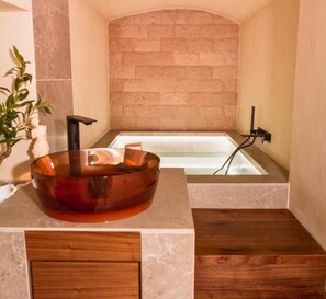 Your private bath ritual begins with aromatherapy salts in the handcrafted cave tub.