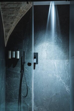 Rejuvenate under a walk-in rain shower, complete with softly scented and skin-loving bath amenities for your comfort.