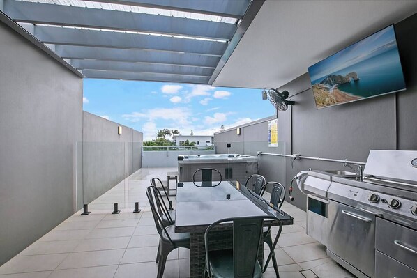 Fire up the BBQ and gather for sunset dinners on your private rooftop, complete with covered dining, a wall-mounted TV, and panoramic skyline views.