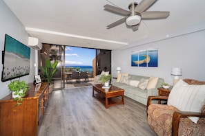 Experience seamless indoor-outdoor living with floor-to-ceiling glass doors leading to a lanai overlooking the Pacific at Kahana Villas F505.