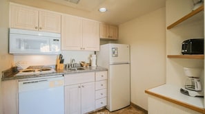 Step into a fully equipped kitchenette, designed for seamless meal preparation, allowing you to enjoy the comforts of home during your stay.