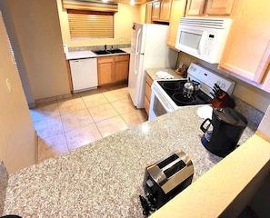 Functional Kitchen – A well-equipped kitchen showcasing modern appliances, ample counter space, and a practical layout.
