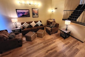 Cozy Living Room – This inviting living room features comfortable seating, stylish decor, and warm lighting.